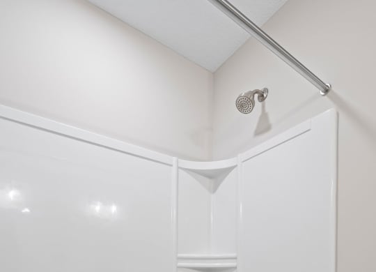 a white bathroom with a shower and a tub