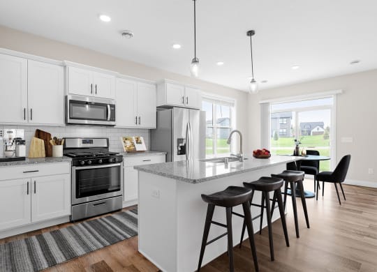an open kitchen with a large island with bar stools
