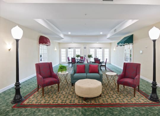 a room with couches chairs and lamps at Arbor Oaks at Greenacres, Greenacres