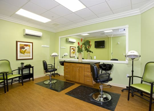a salon room with green walls and black and white chairsat Arbor Oaks at Lakeland Hills, Lakeland 