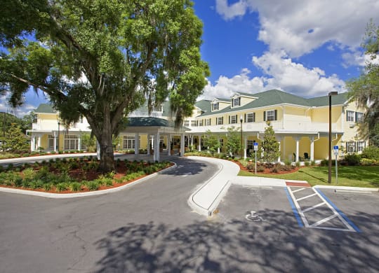 a building with a parking lot in front of itat Arbor Oaks at Lakeland Hills, Lakeland, FL 33805
