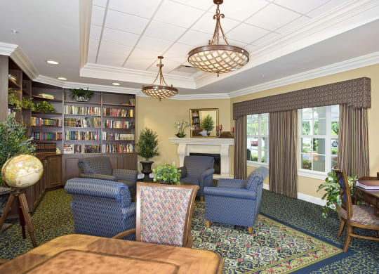 a lobby with couches chairs and a fireplace at Arbor Oaks at Lakeland Hills, Lakeland, FL