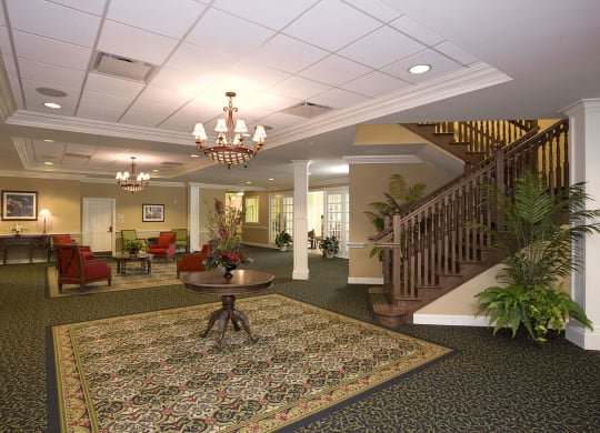 a large lobby with a staircase and chandelier at Arbor Oaks at Lakeland Hills, Florida