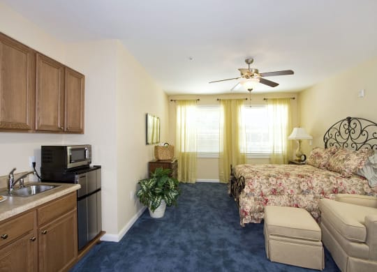 a bedroom with a bed and a couch in a roomat Arbor Oaks at Lakeland Hills, Florida