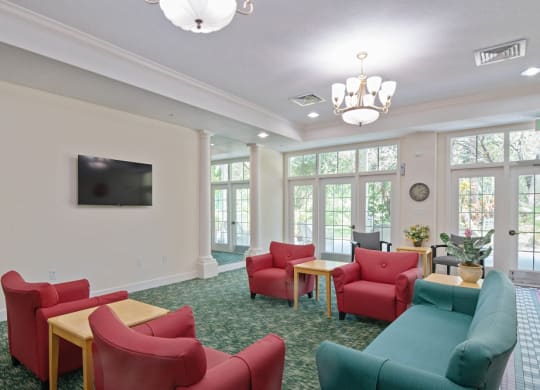 a room with couches chairs and a televisionat Arbor Oaks at Greenacres, Greenacres, FL