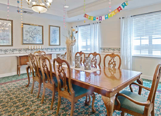 a dining room with a wooden table and chairsat Arbor Oaks at Greenacres, Greenacres Florida