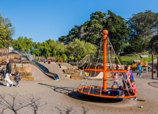 a playground with a swing set and a slide