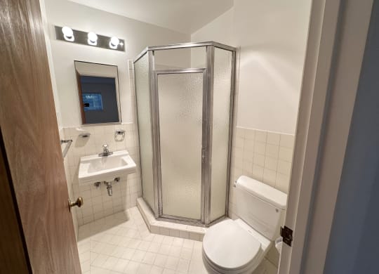 a bathroom with a toilet sink and shower