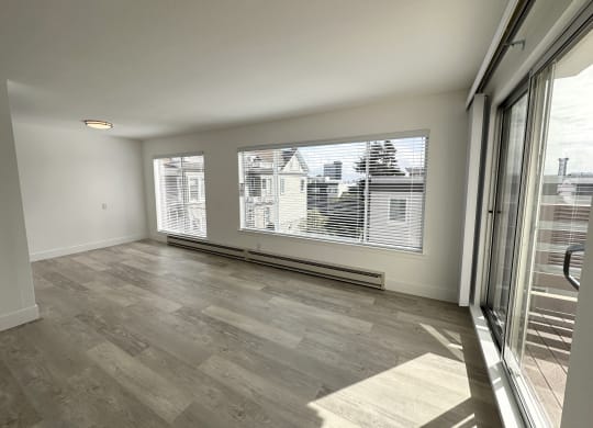 a bedroom with a large window and a sliding glass door