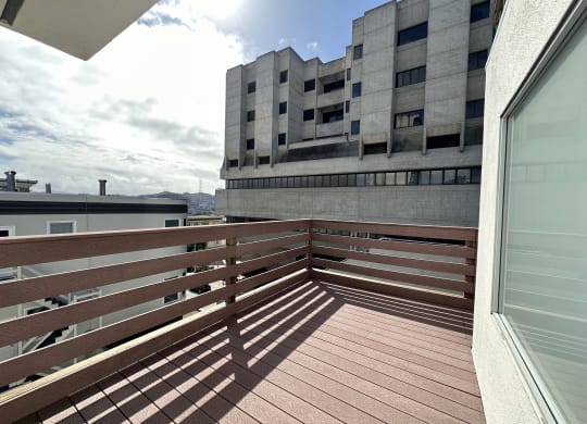 a view from a balcony of a building with a blue sky in the background