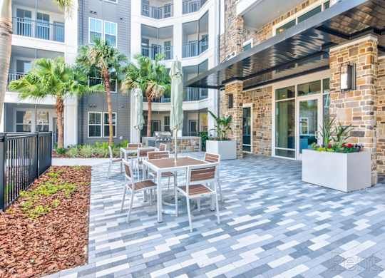 A patio with a table and chairs at Tapestry Nona in Orlando, FL