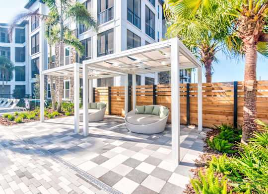 A patio area with a white pergola at Tapestry Nona in Orlando, FL
