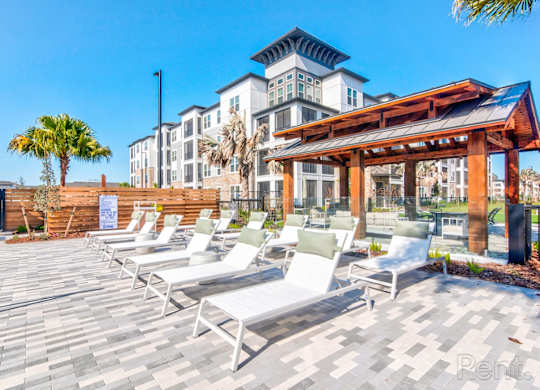 Pool area with chaise lounges at Tapestry Nona in Orlando, FL