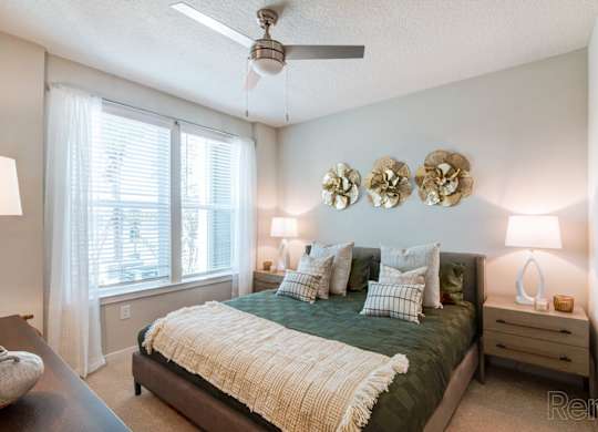 A bedroom with a ceiling fan, and a window with blinds at Tapestry Nona in Orlando, FL