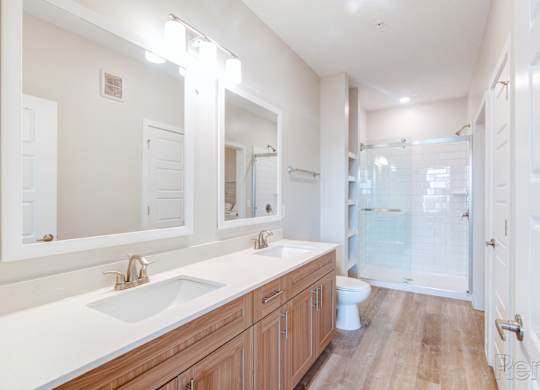 Primary bathroom with double vanity and stand-alone shower at Tapestry Nona in Orlando, FL