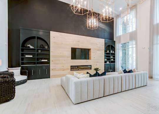 Clubhouse with seating and entertainment space at Tapestry Nona Apartments in Orlando, FL