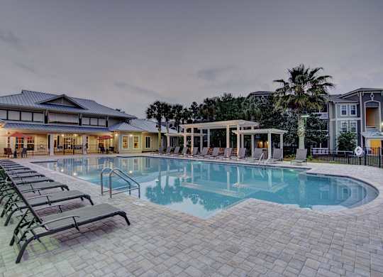 A large outdoor swimming pool surrounded by lounge chairs.