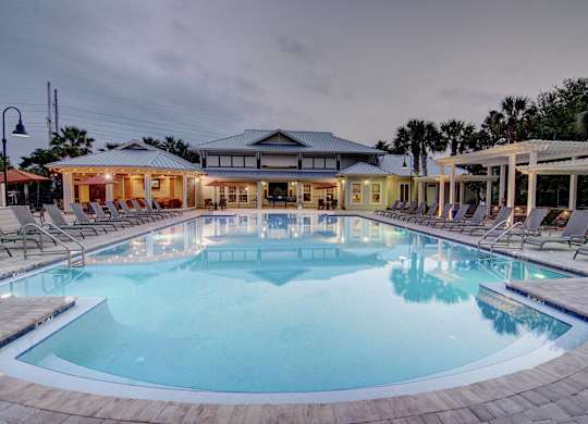 A large outdoor swimming pool with a building in the background.