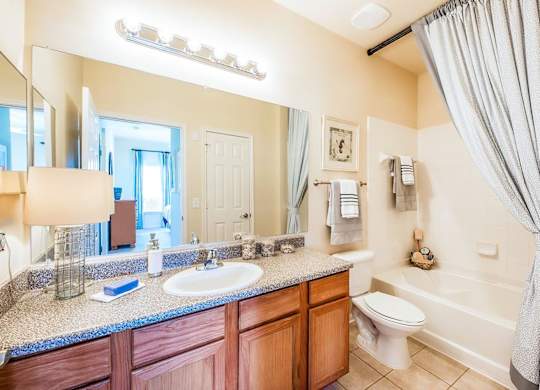 A bathroom with a sink, toilet, and bathtub.