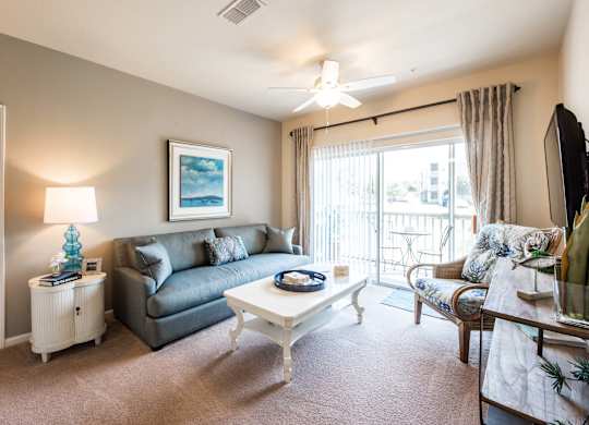 A living room with a grey couch and a white coffee table.