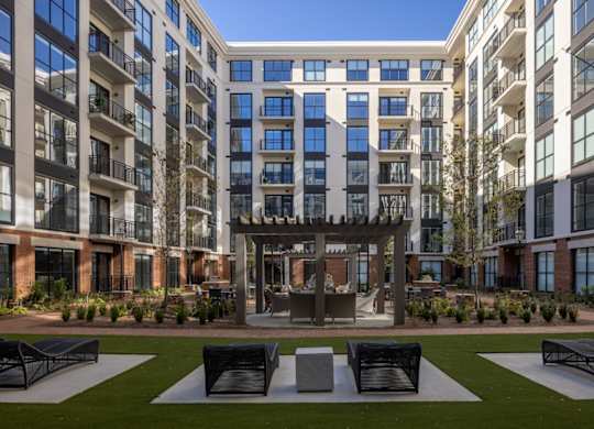 Modern mid-rise building with courtyard and social area at 2020 Providence in Huntsville, AL