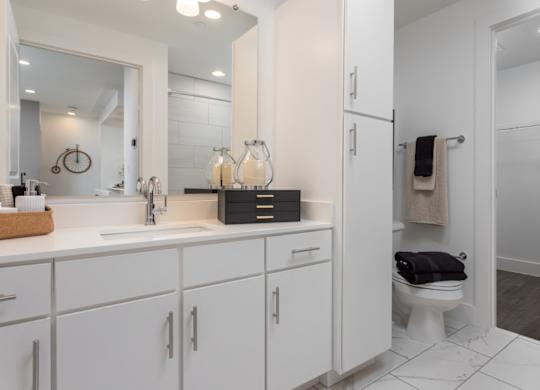 Modern bathroom with wood floors and attached walk-in closet at 2020 Providence in Huntsville, AL