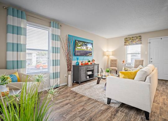 roomy living room with ample natural light and plank flooring at 701 South Apartments in Mobile, AL