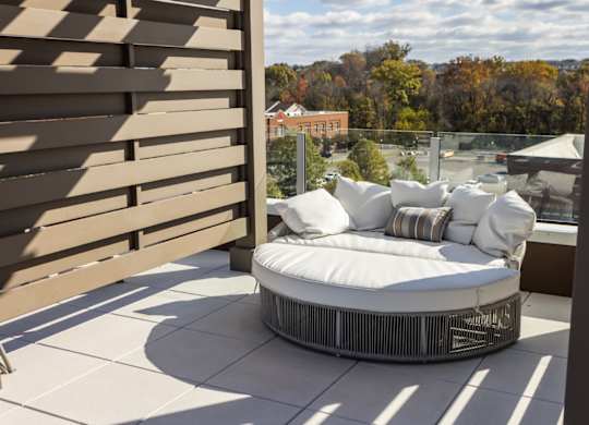 Rooftop, poolside cabana with white lounge chairs at 2020 Providence in Huntsville, AL
