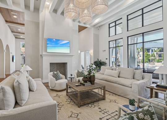 A living room with a fireplace and a large screen TV.