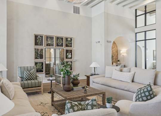 A living room with a couch, chairs, and a coffee table.