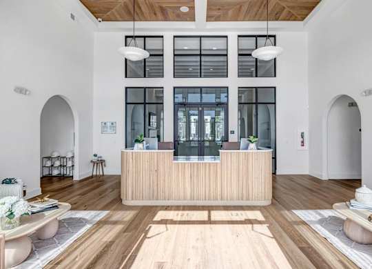 A reception area with a wooden counter and a large window.