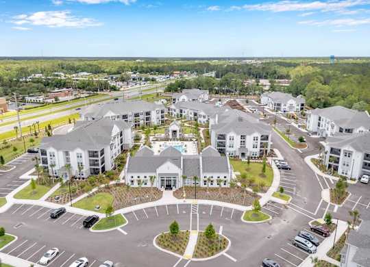 A large, modern building complex with a circular driveway in the foreground.