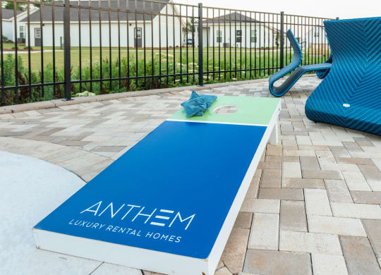 pool area with yard games pool area with pergola, couches, and yard games at Anthem Apartments and Cottages in Huntsville, Alabama