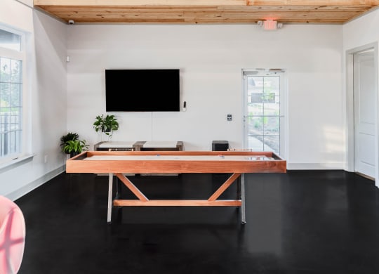 a rec room with game table and a tv at Anthem Apartments and Cottages in Huntsville, Alabama