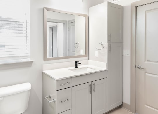 a bathroom with modern fixtures, linen cabinet, and storage at Anthem Luxury Rentals and Apartment Homes and Cottages