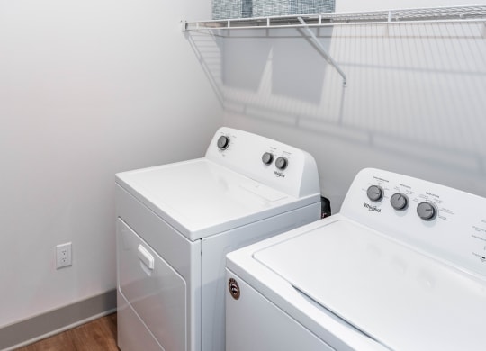 full size washer/dryer in a laundry room at Anthem Luxury Rentals and Apartments in Huntsville, AL