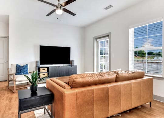 modern and open concept living room with wood floors at Anthem Apartments and Cottages in Huntsville, Alabama