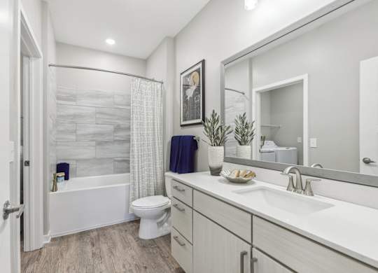 a bathroom with a shower and a sink and a toilet
