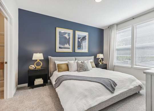 the preserve at ballantyne commons bedroom with blue accent wall and large windows