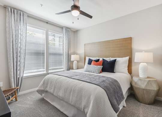 a bedroom with a bed and a ceiling fan