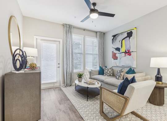 a living room with a couch and a ceiling fan