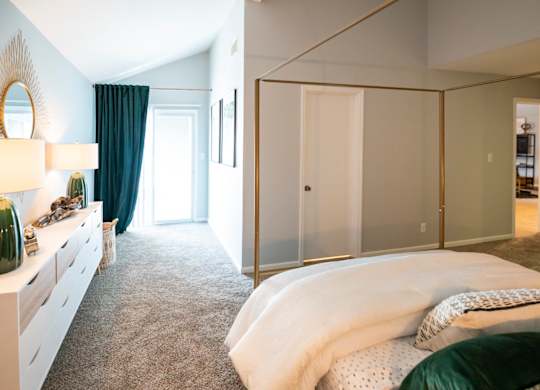 oversized bedroom with patio access at Saddlebrook at Tates Creek Apartments in Lexington, KY