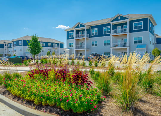 Classic apartment buildings with beautiful landscaping at Anthem Apartments and Cottages in Huntsville, Alabama