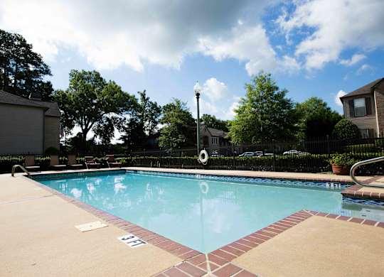swimming pool and seating at Village at Caldwell Mill Apartments in Birmingham, Alabama