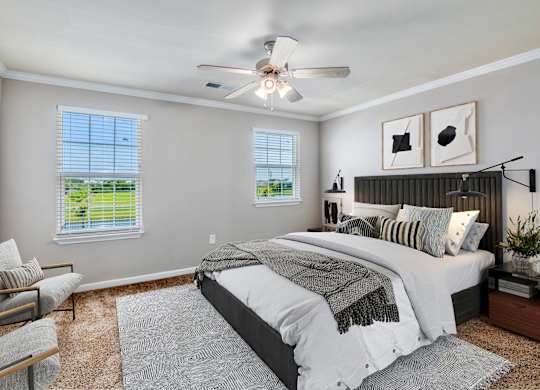 a bedroom with a bed and a ceiling fan