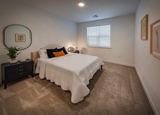 Carpeted bedroom with window at Wesley Place Apartments in Indianapolis, IN