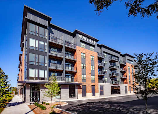 Wesley Place is a modern apartment building with a mix of brick and panel facades at Wesley Place Apartments in Indianapolis, IN