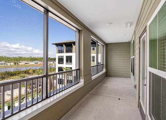 A balcony with a view of a building and trees.