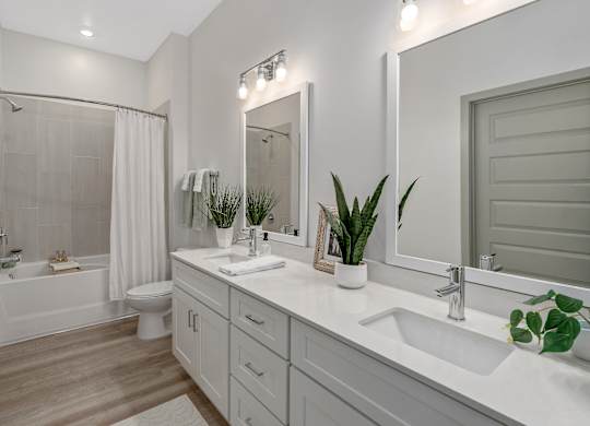 A white bathroom with a white tub and sink.