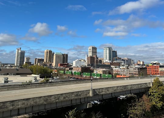 A cityscape view from the Fitzroy Apartments with a bridge in the foreground and downtown skyline in Birmingham Alabama.